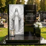 modern black granite headstone with glass memorial panel featuring Jesus, engraved nameplate and flowers