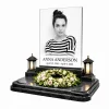 glass photo plaque for grave with engraved name and dates on black granite headstone