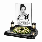 glass photo plaque for grave with engraved name and dates on black granite headstone