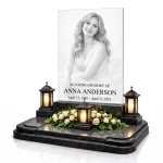 Glass photo plaque for grave engraved with portrait, name and dates on granite base
