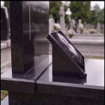 glass photo plaque for grave mounted on black granite headstone
