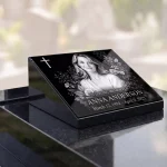 glass memorial panel with engraved photo, name and dates on granite headstone