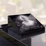 glass photo plaque for grave with engraved portrait, name and dates on granite headstone