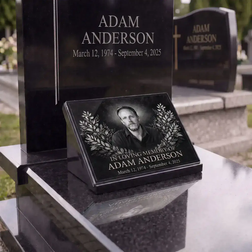 Glass photo plaque for grave with engraved portrait, name and dates on granite headstone