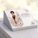 Glass memorial panel with photo, name and dates on a headstone