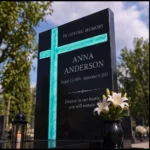 Asymmetric fused-glass cross set into a black granite headstone