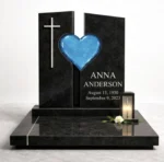 blue fused glass heart on a black granite headstone