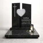 crushed glass heart mounted on a black granite headstone
