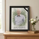 Framed memorial portrait of deceased made from photo with floral surround