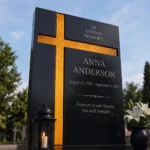 Gold asymmetric glass cross bonded to a black granite headstone