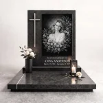 black and white photo for grave with floral engraving on granite headstone