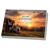 Memorial plaque in glass with a football, scarf and goal at sunset, on a granite base