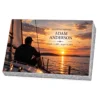 Memorial plaque in glass with a sailor on the deck of a yacht at sunset, on a granite base