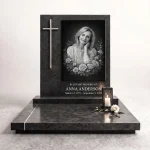 Black and white memorial plaque with photo on granite headstone