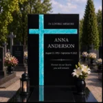 Turquoise fused-glass cross on a black granite headstone