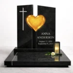 yellow fused glass heart on a black granite headstone