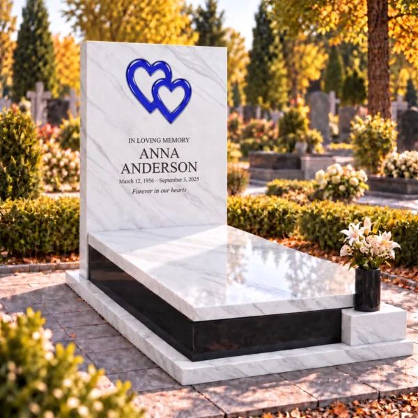 cobalt blue interlocking glass hearts set into the stone tablet of a headstone, view from the left