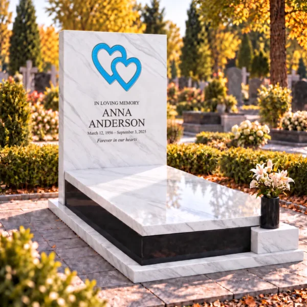 crackled light blue interlocking glass hearts set into the stone tablet of a headstone, view from the left