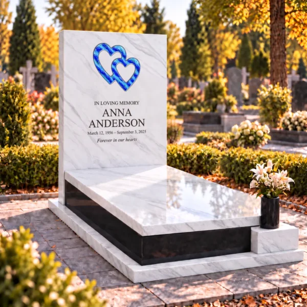 interlocking glass hearts with blue stripes set into the stone tablet of a headstone, view from the left