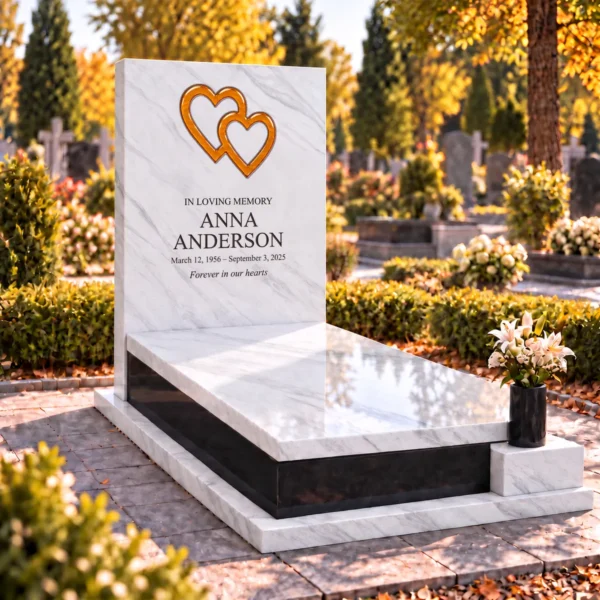 orange interlocking glass hearts set into the stone tablet of a headstone, view from the left