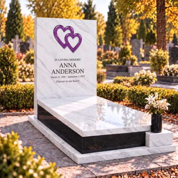 purple interlocking glass hearts set into the stone tablet of a headstone, view from the left