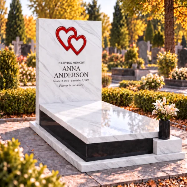 red interlocking glass hearts set into the stone tablet of a headstone, view from the left