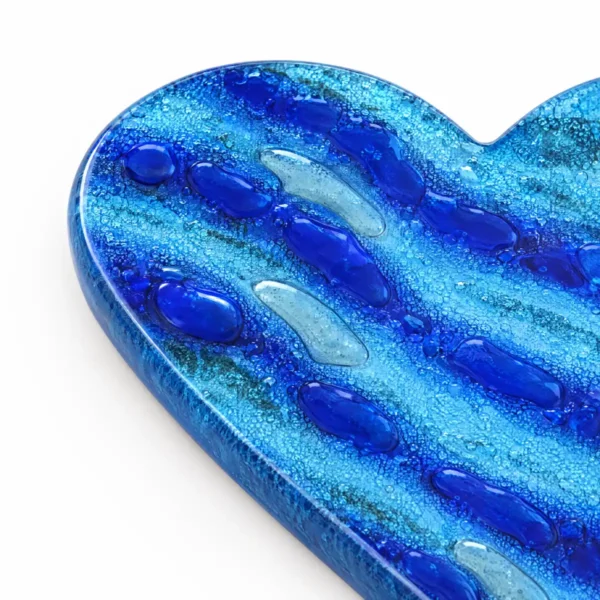 transparent glass heart with blue stripes for a headstone, close-up of the glass texture